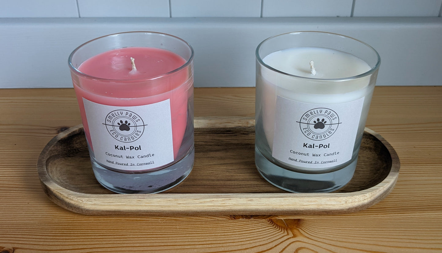 Pink Cal-Pol candle on left with White Cal-Pol candle on right sat on a wooden tray 